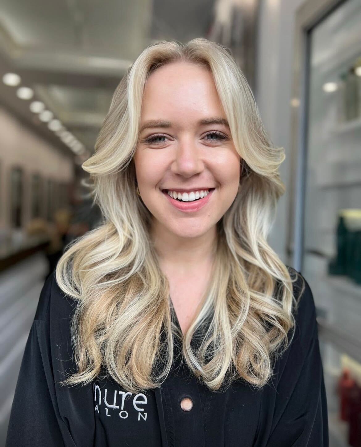 Client experiencing the luxury of personalized blonde balayage at Mure Salon