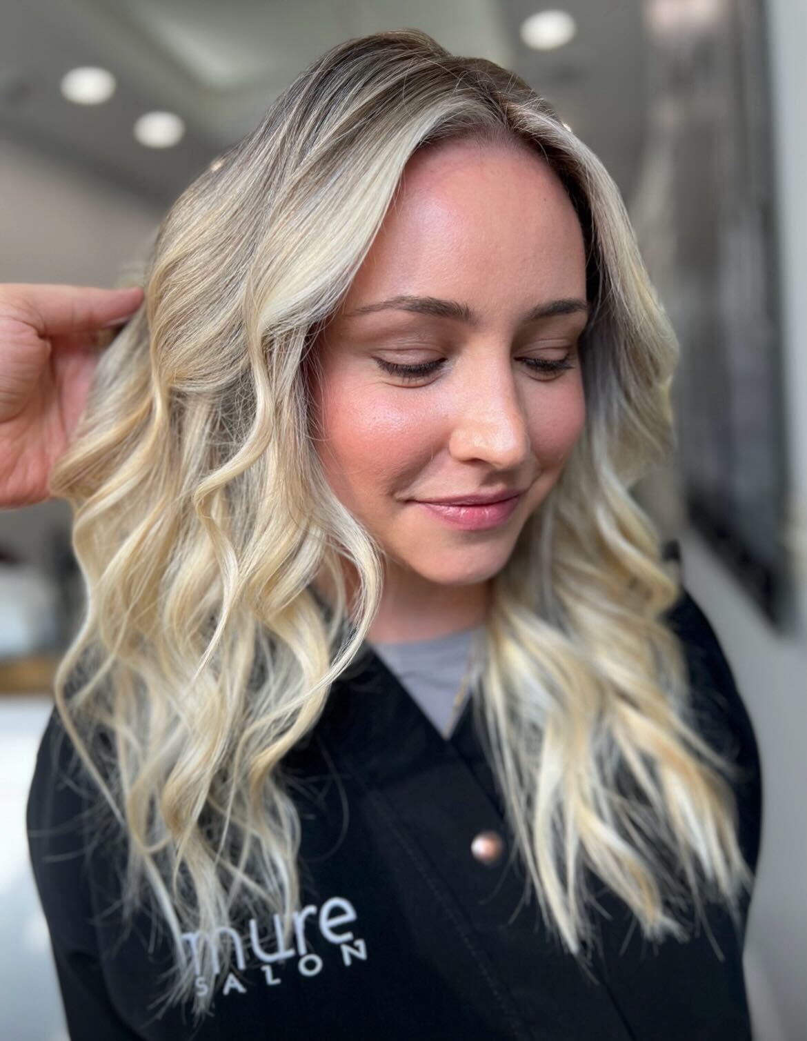 Stylist creating blonde balayage at Mure Salon in NYC